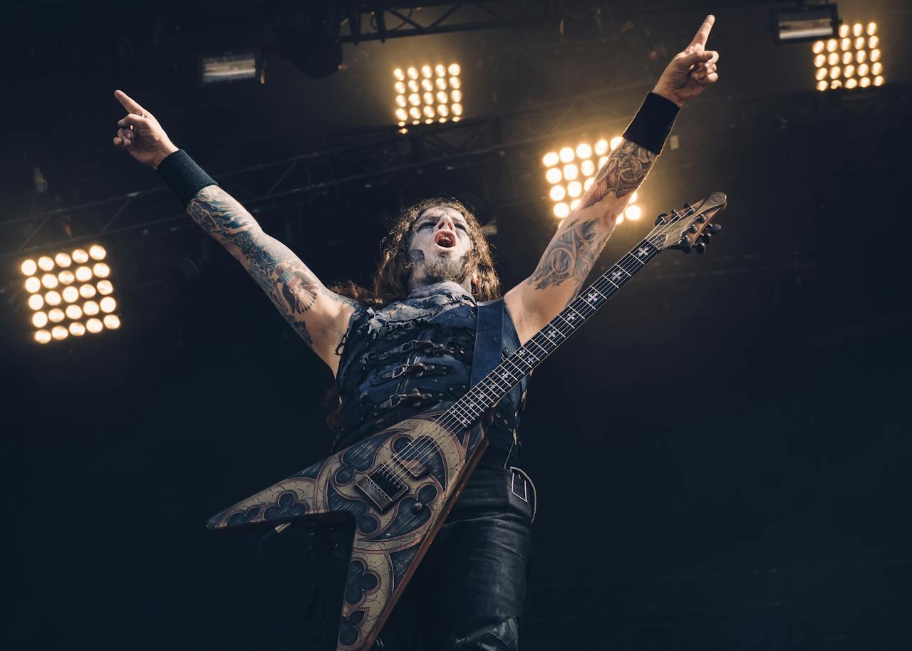 A metal rock star striking a pose on stage