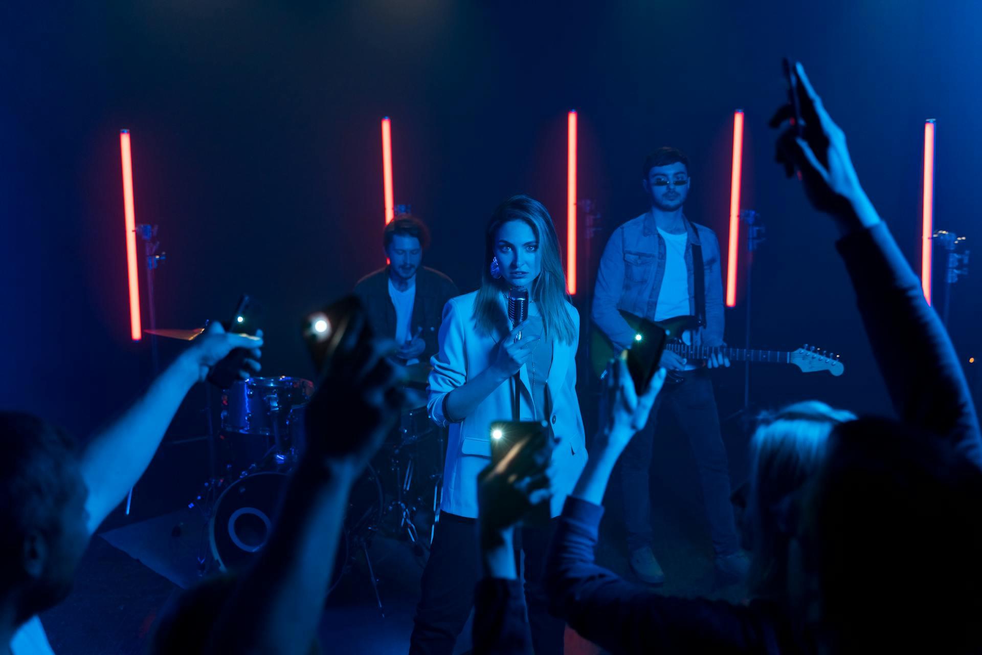 A band playing live at a night club with blue lights