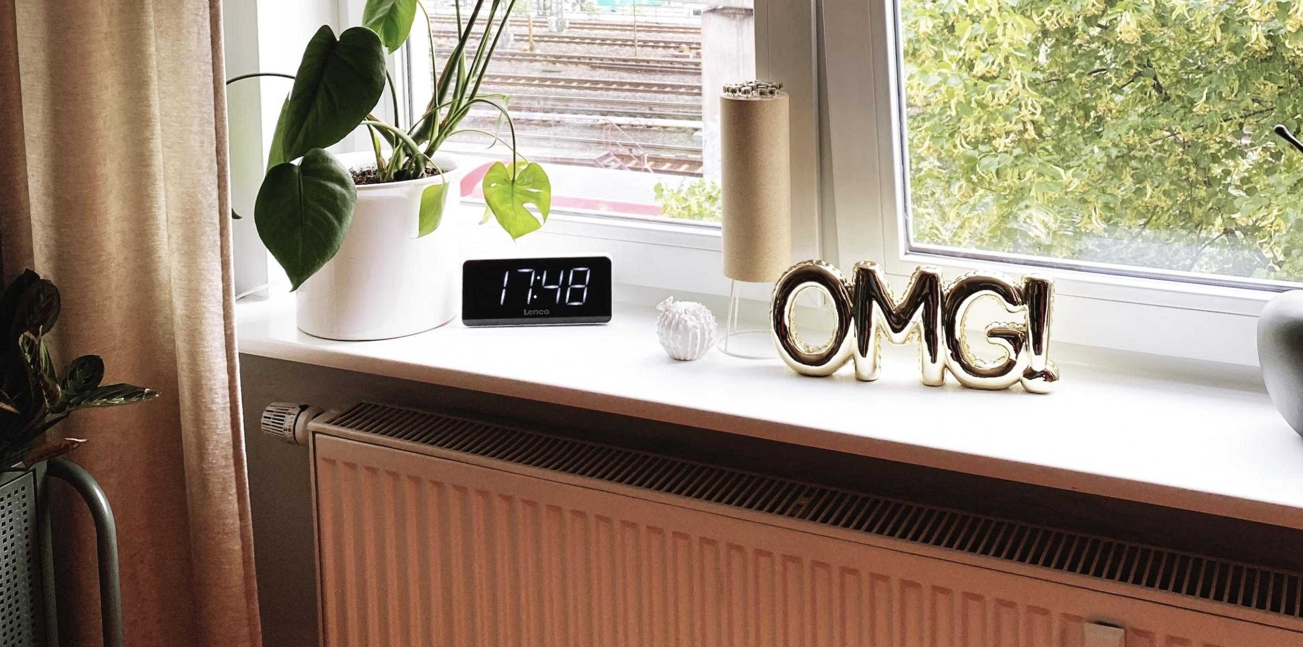 table by the window with 'OMG' sign