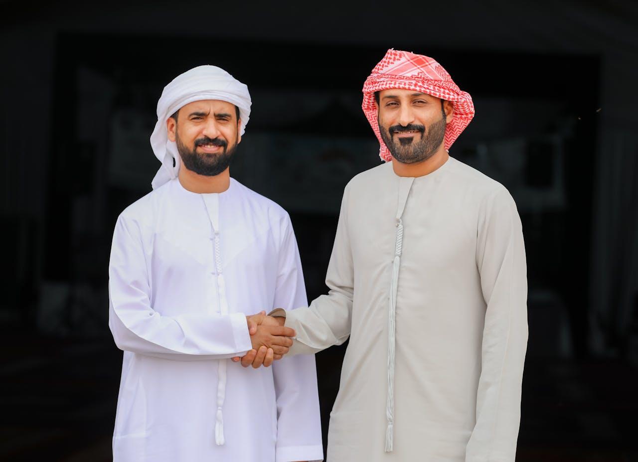Middle Eastern Men Shaking Hands in Traditional Attire