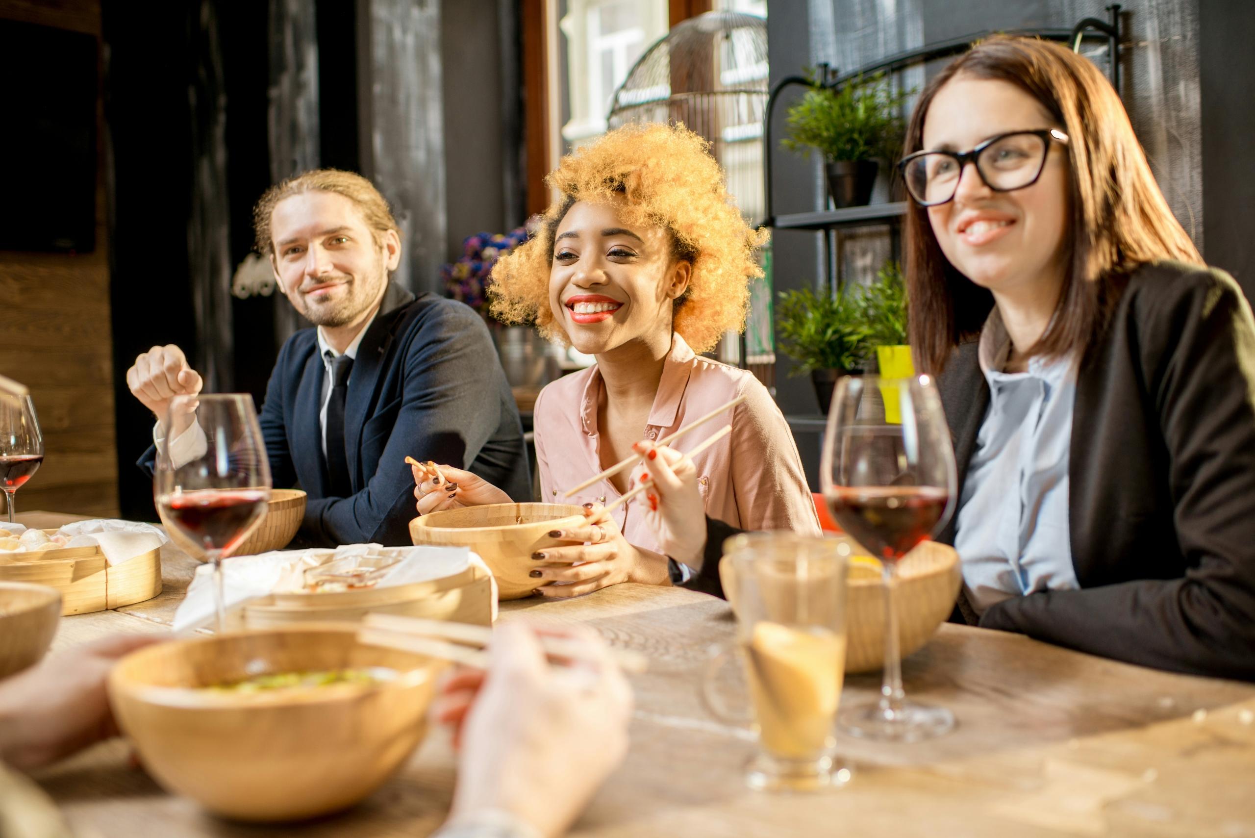 Three people enjoying a meal together.