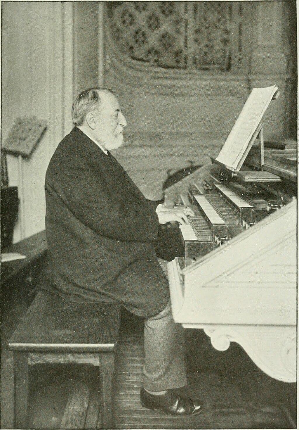 A photo of Camille Saint-Saëns at a piano