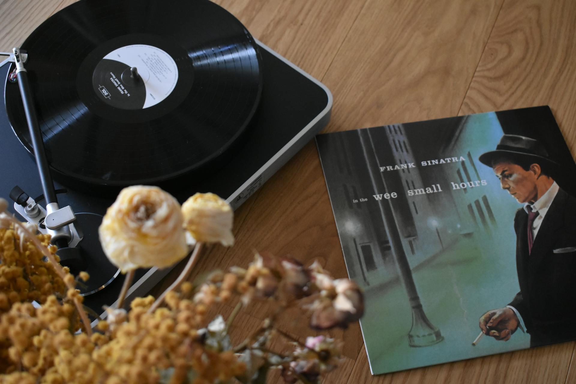 a Frank Sinatra record on a turntable with the sleeve nearby