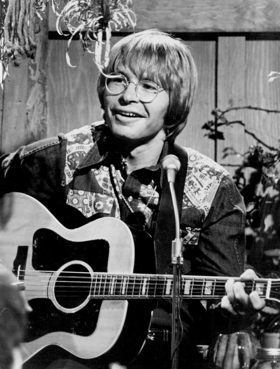 John Denver playing guitar
