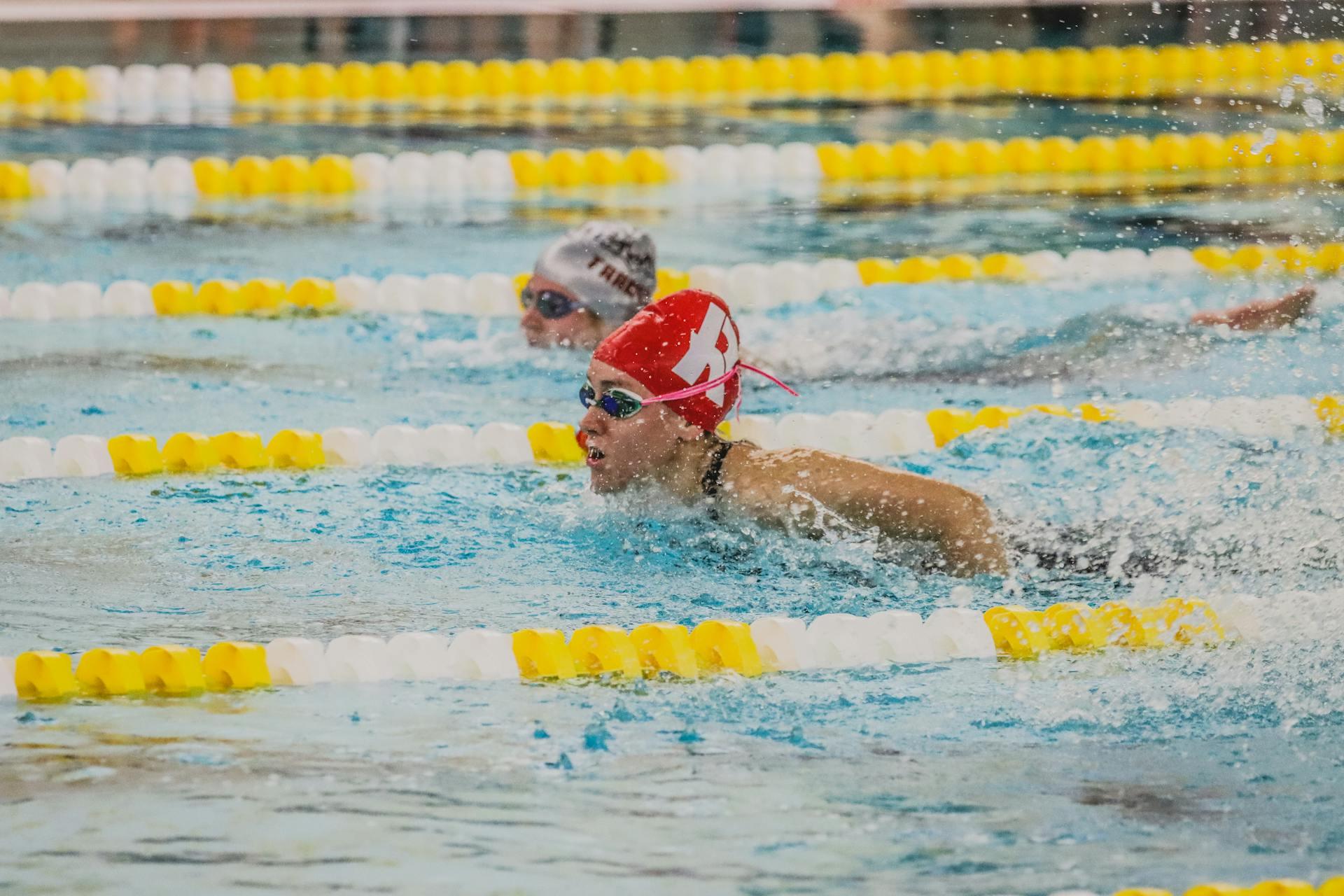 two ladies swimming butterfly stroke