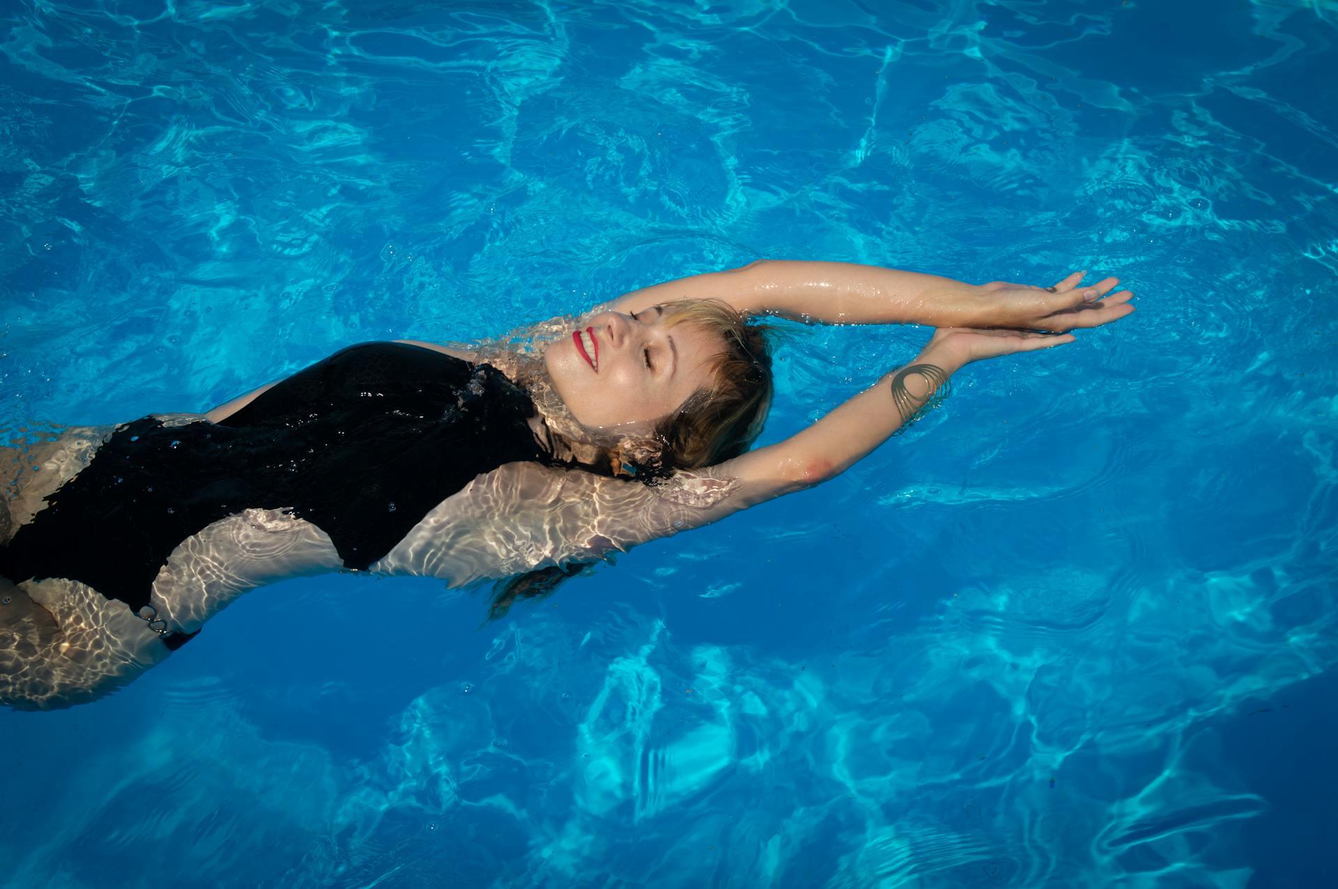 a lady floating in pool