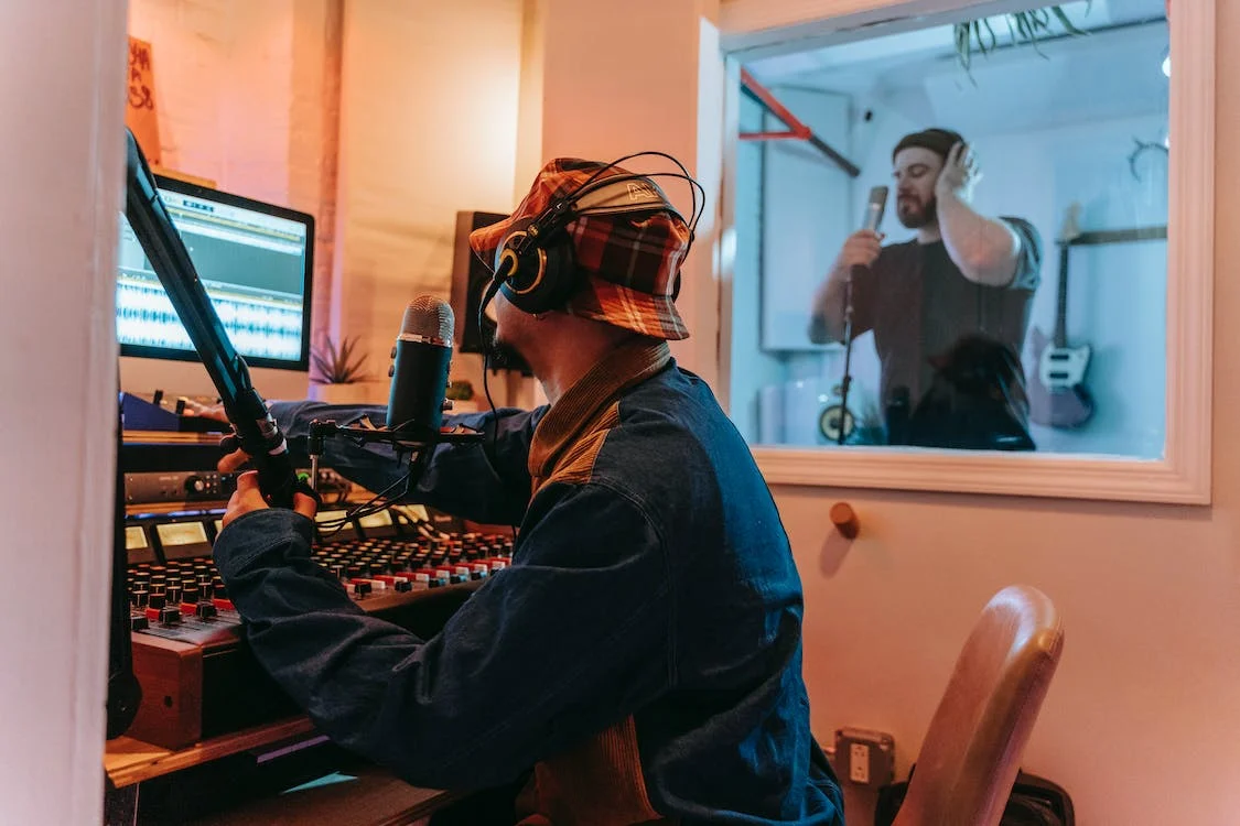Two men in a recording studio.