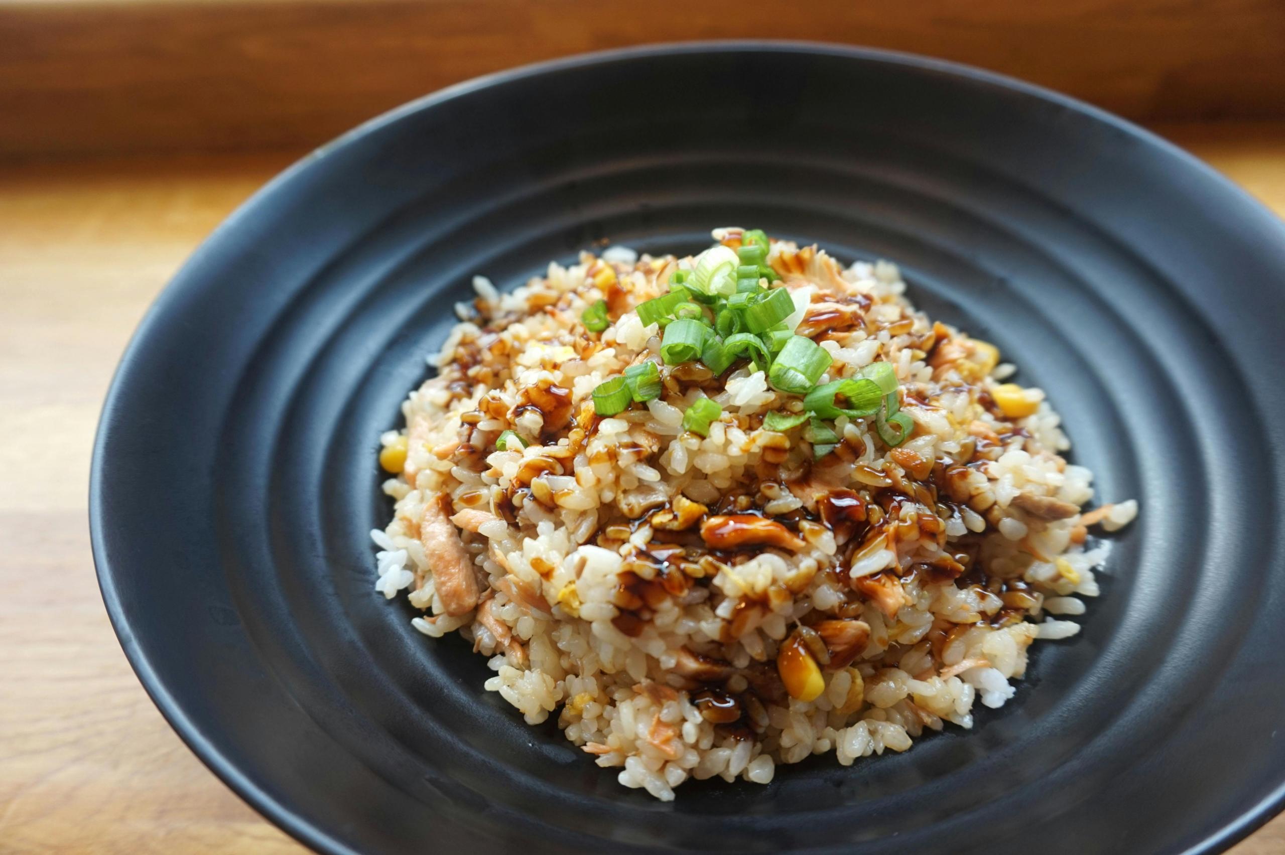 A plate of stick rice topped with green onion