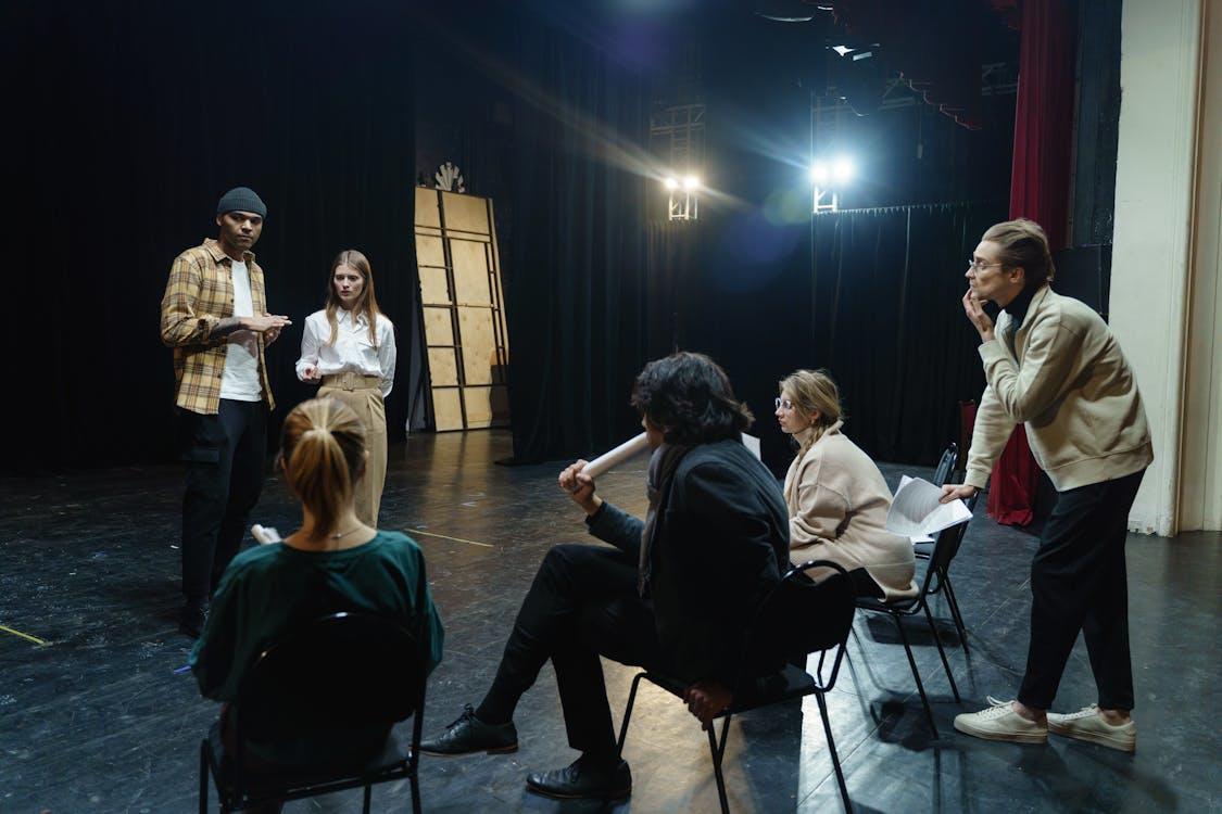 A group of people on a stage, participating in voice acting auditions.