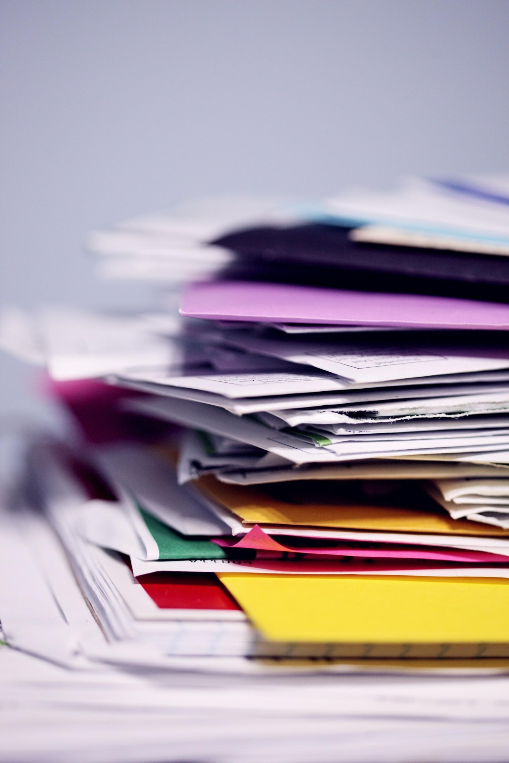 pile of books and folders of various colours 