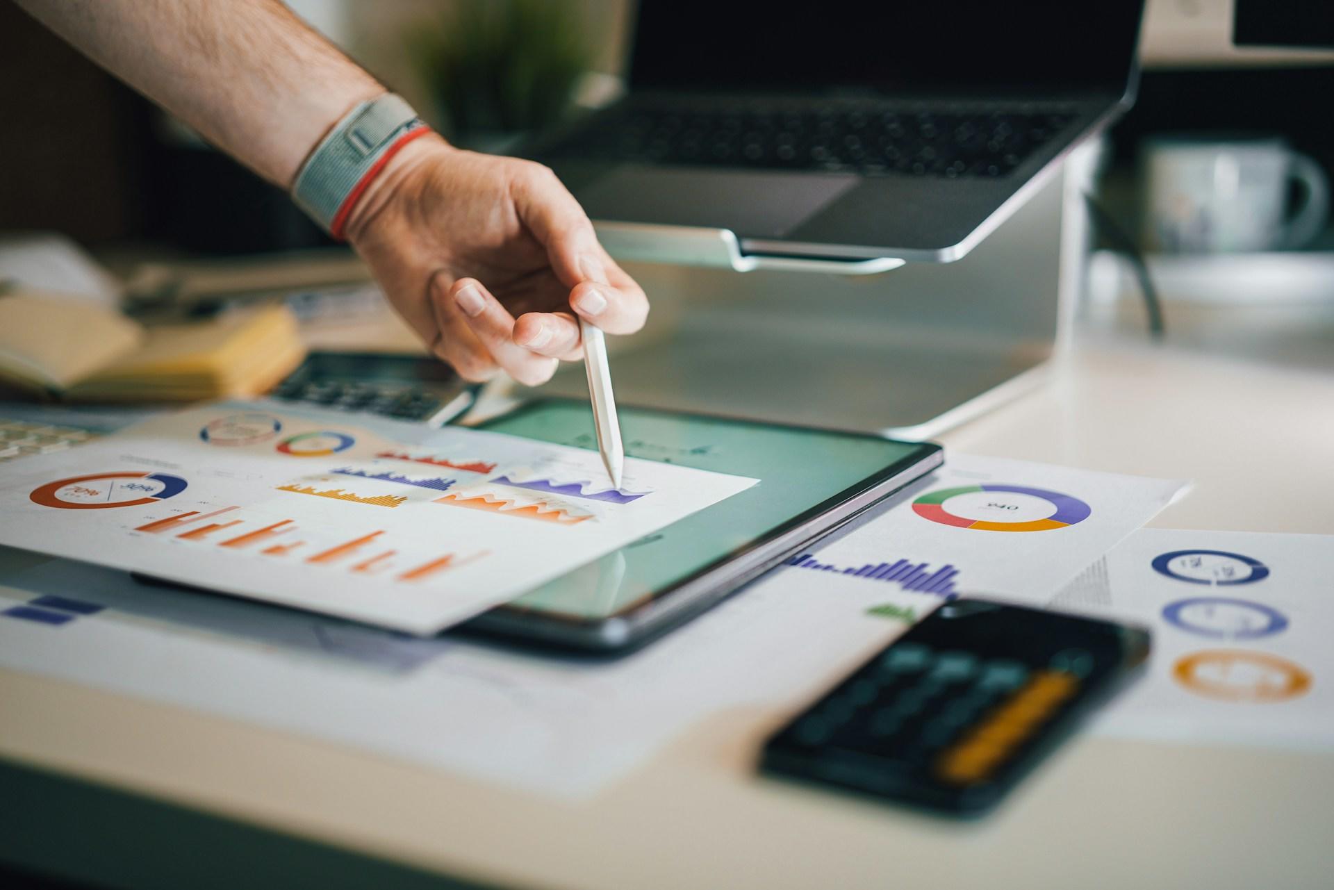 People looking at printed graphs and charts.