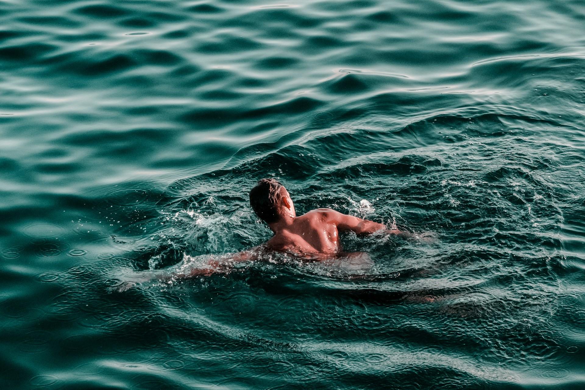 A man swimming in open waters.