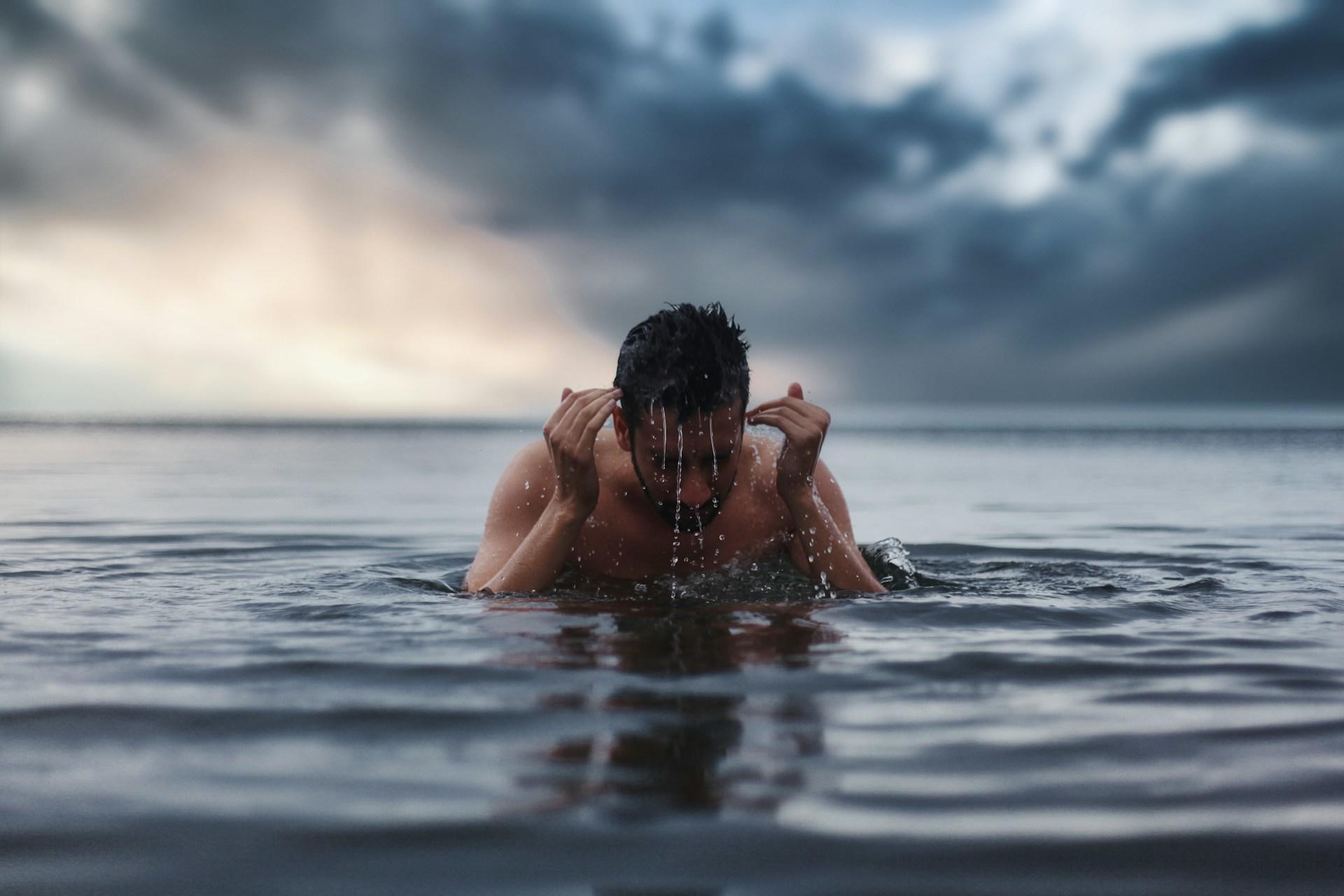 A person emerging from the ocean.