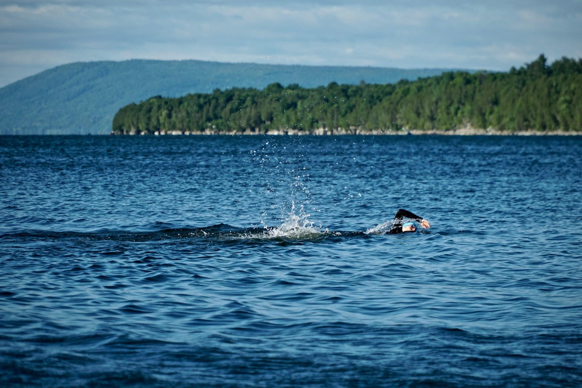 A person wild swimming in a lake.