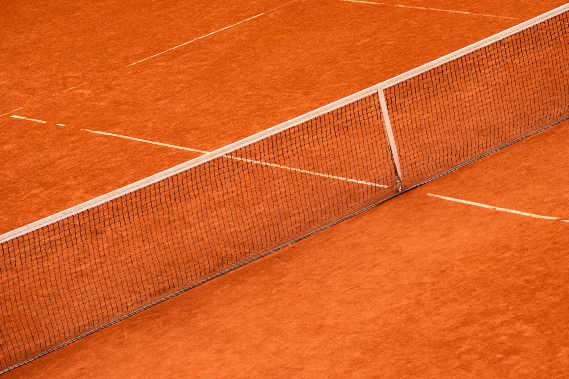 A clay tennis court and net.