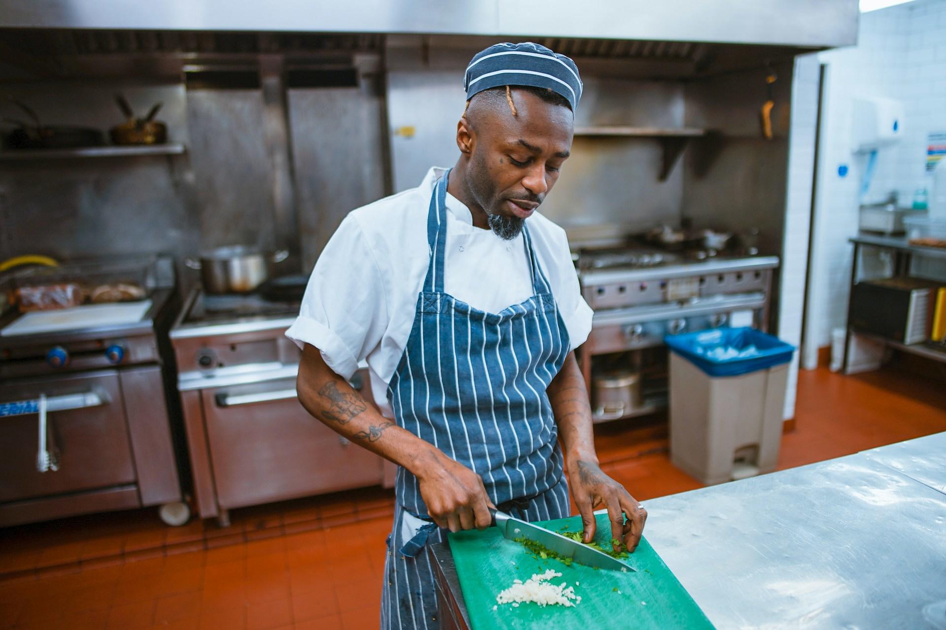A man preparing for service by cutting the ingredients.