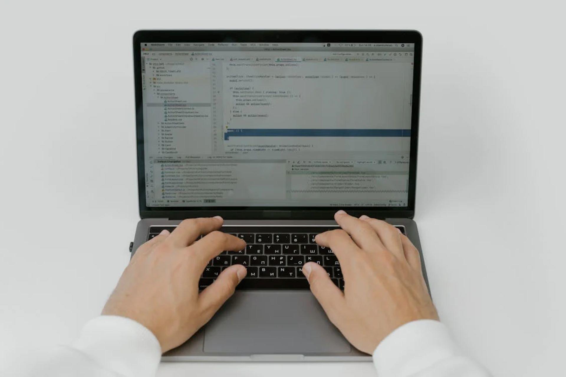 A person typing on a laptop