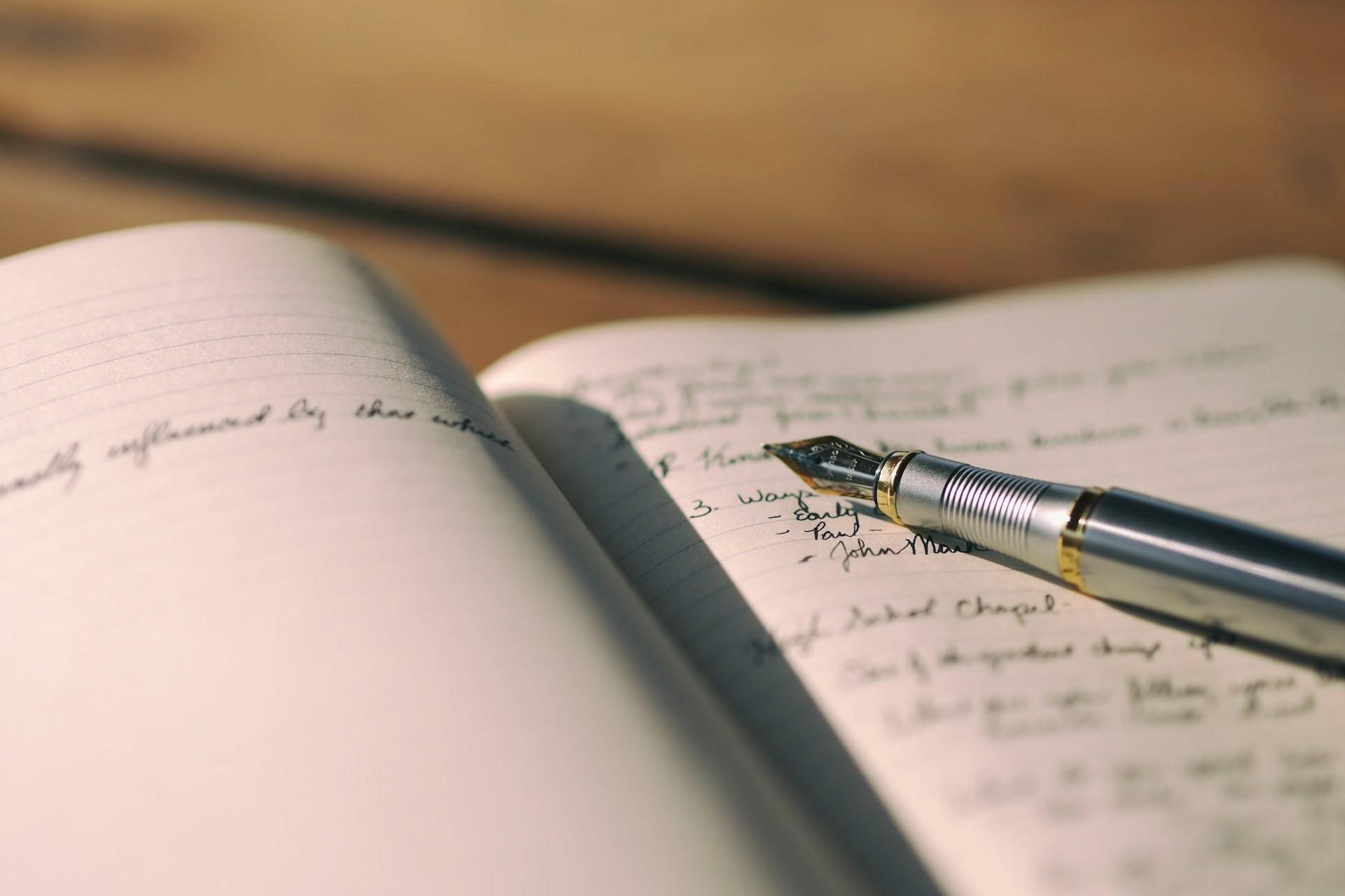 A fountain pen on the page of a notebook.