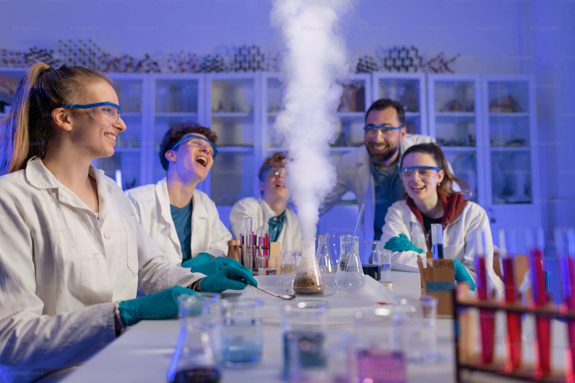 A group of university students and their professor observing a chemical reaction in a laboratory.