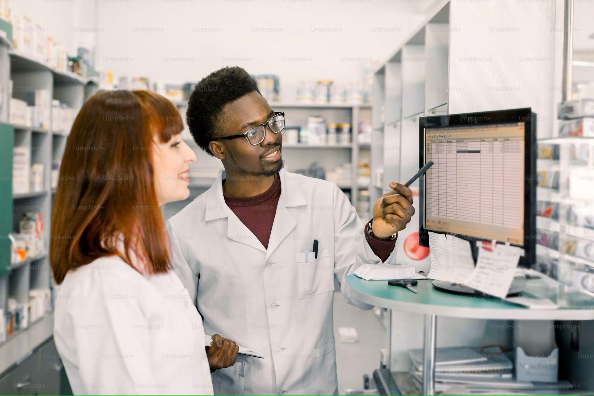 Two pharmacists in lab coats working in a pharmacy.