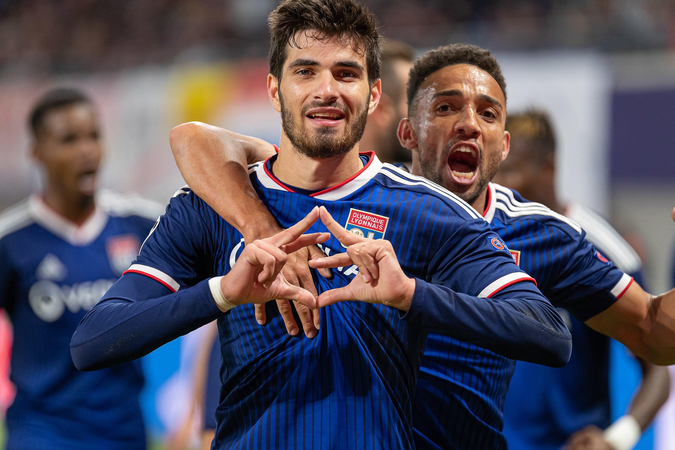 Two Olympique Lyonnais players celebrating