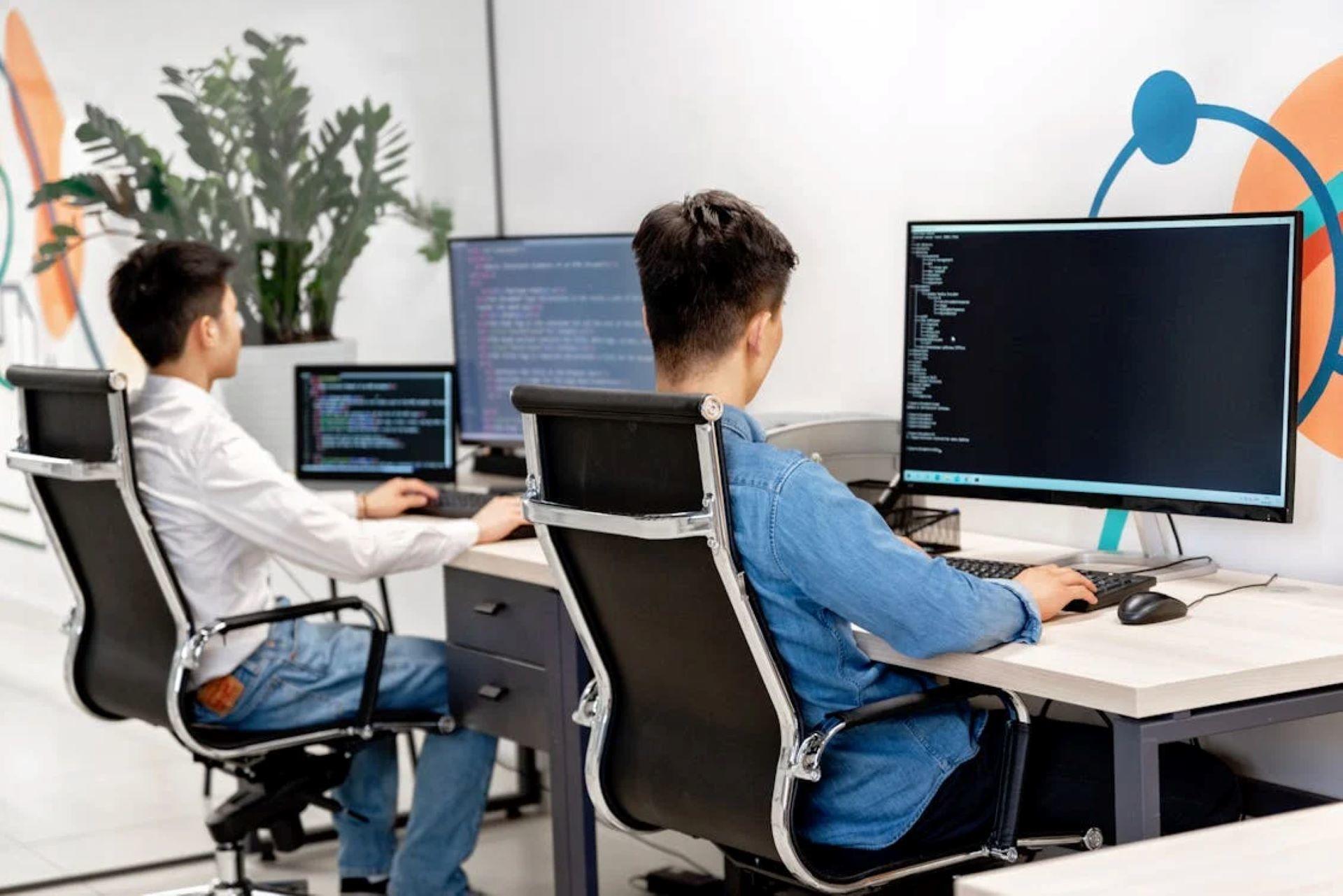 Two people working collaboratively on Python code