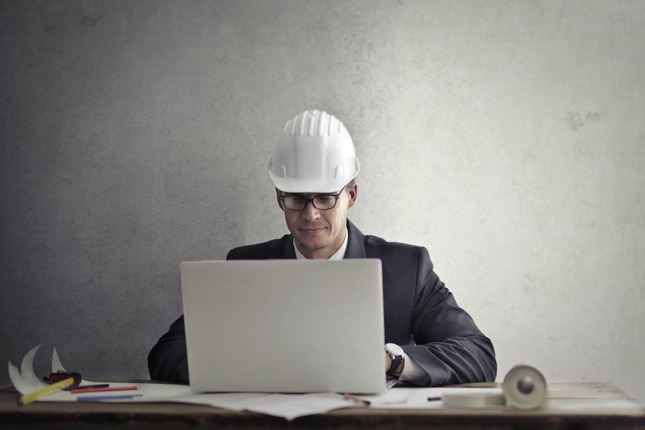 work experience man with hard hat in front of computer