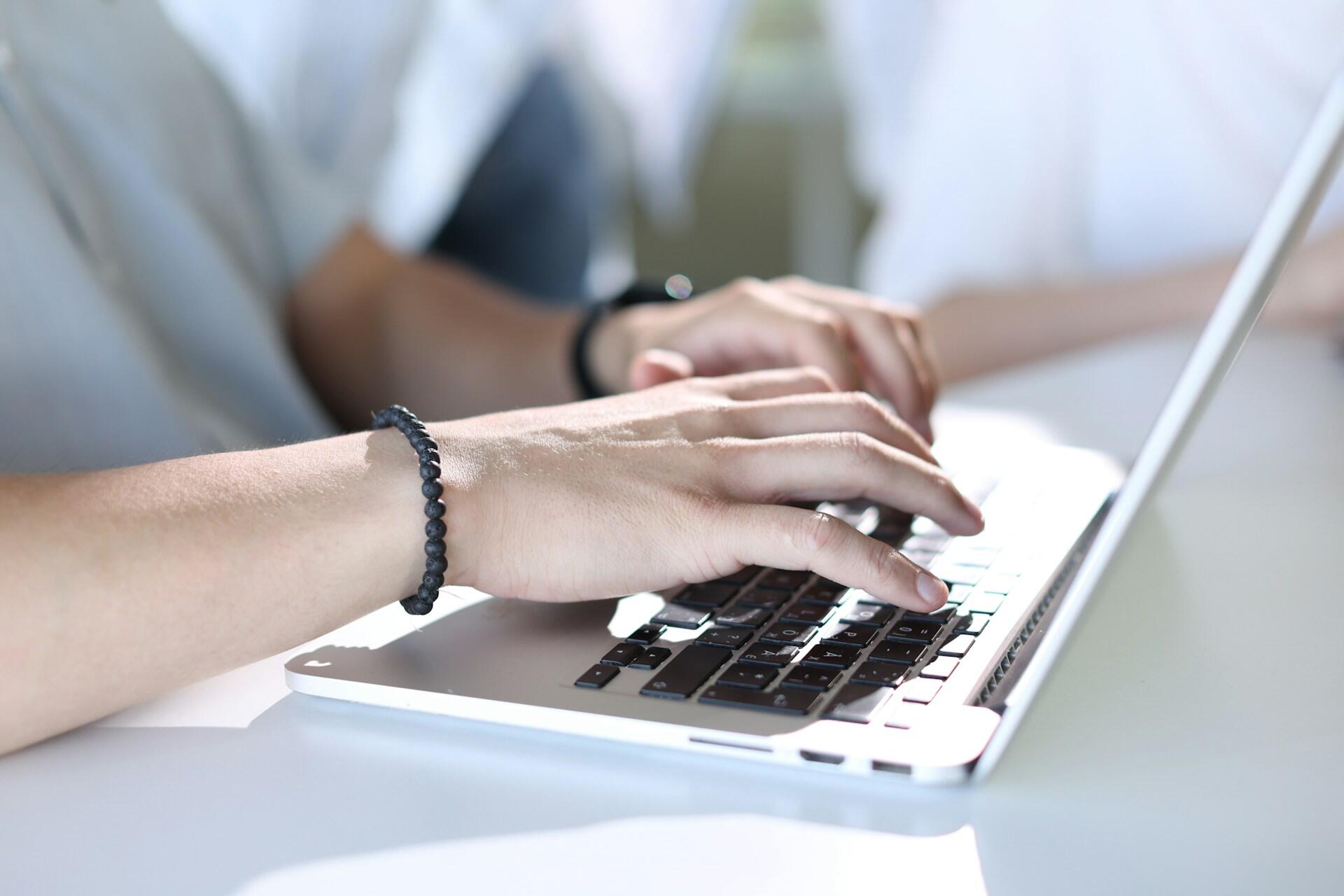 A student using a laptop computer to type.