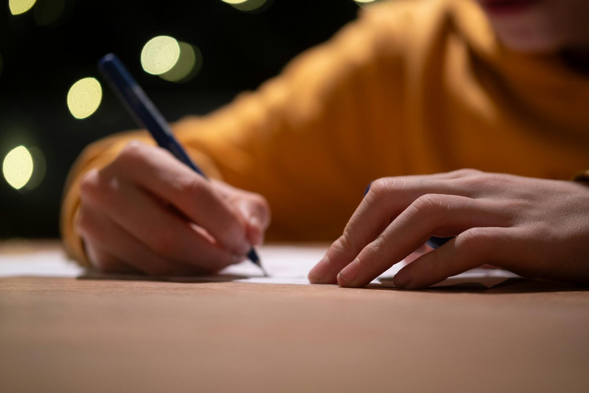 A student writing a letter.