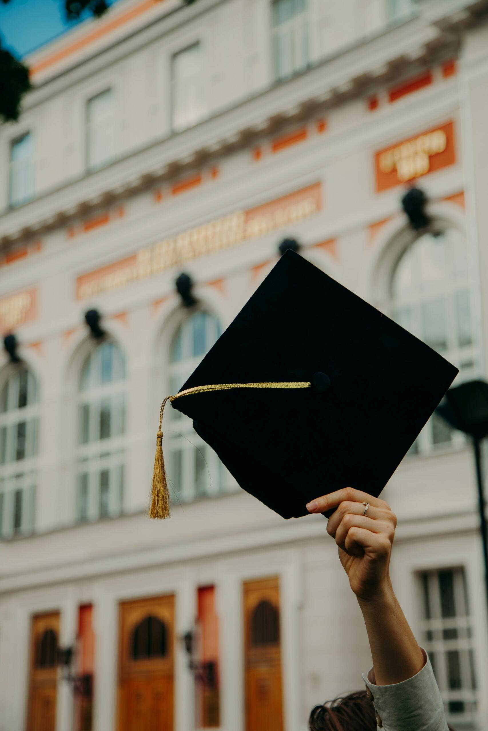 A university mortarboard hat in the air.