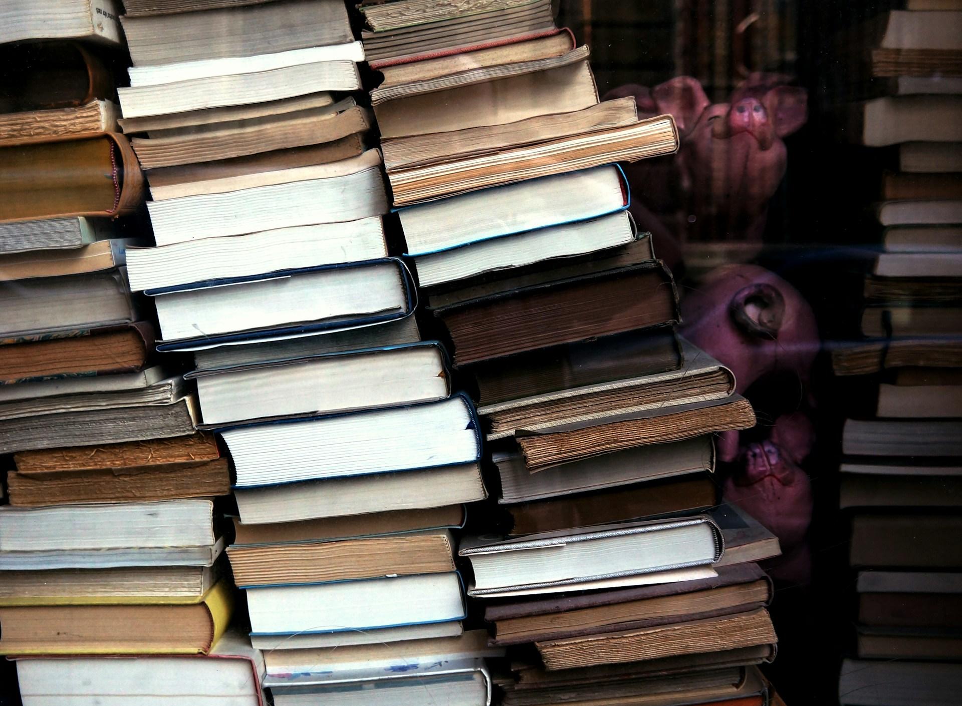 A neat stack of books, showcasing various titles and sizes, ready to be explored and enjoyed.
