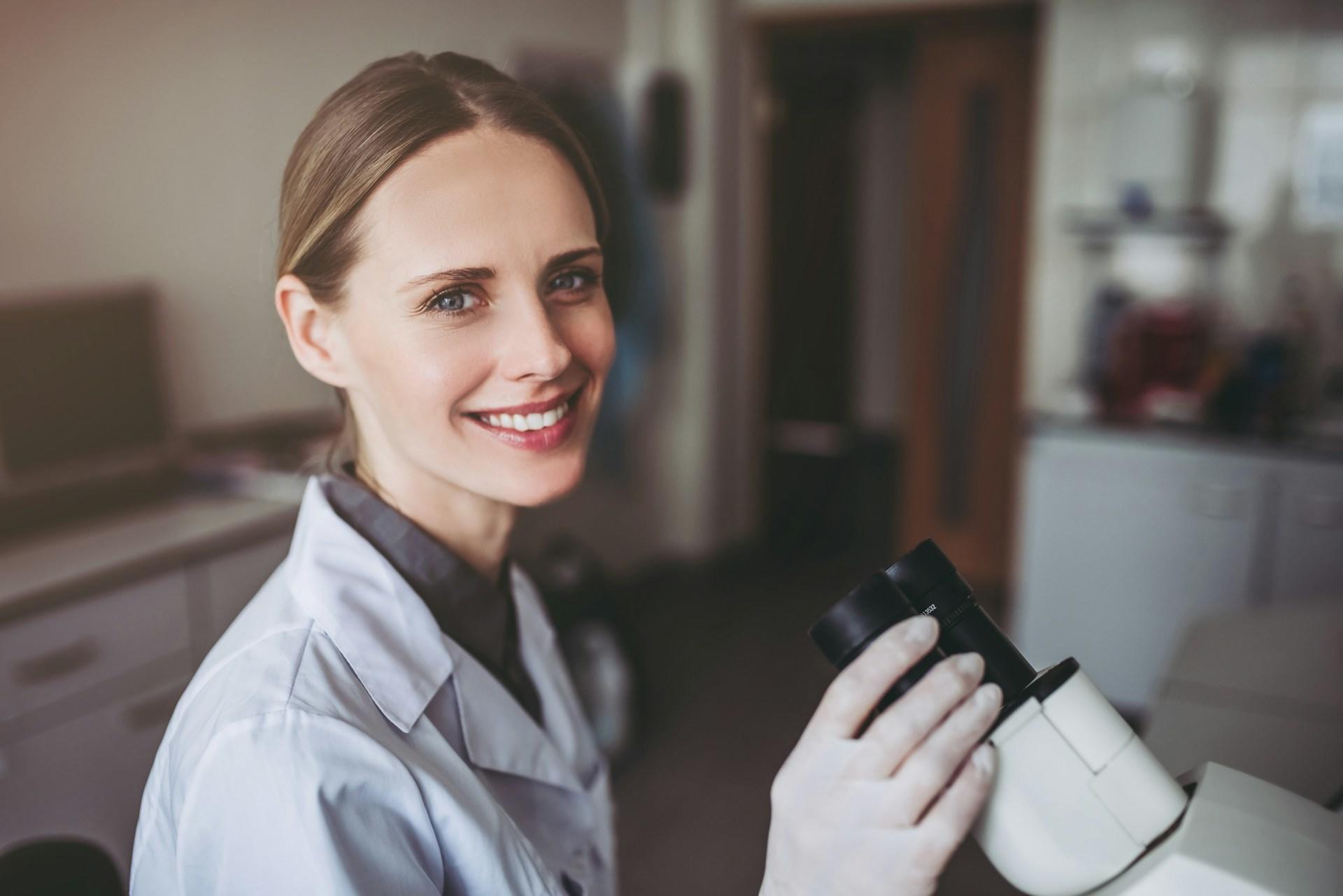 female chemist with a microscope