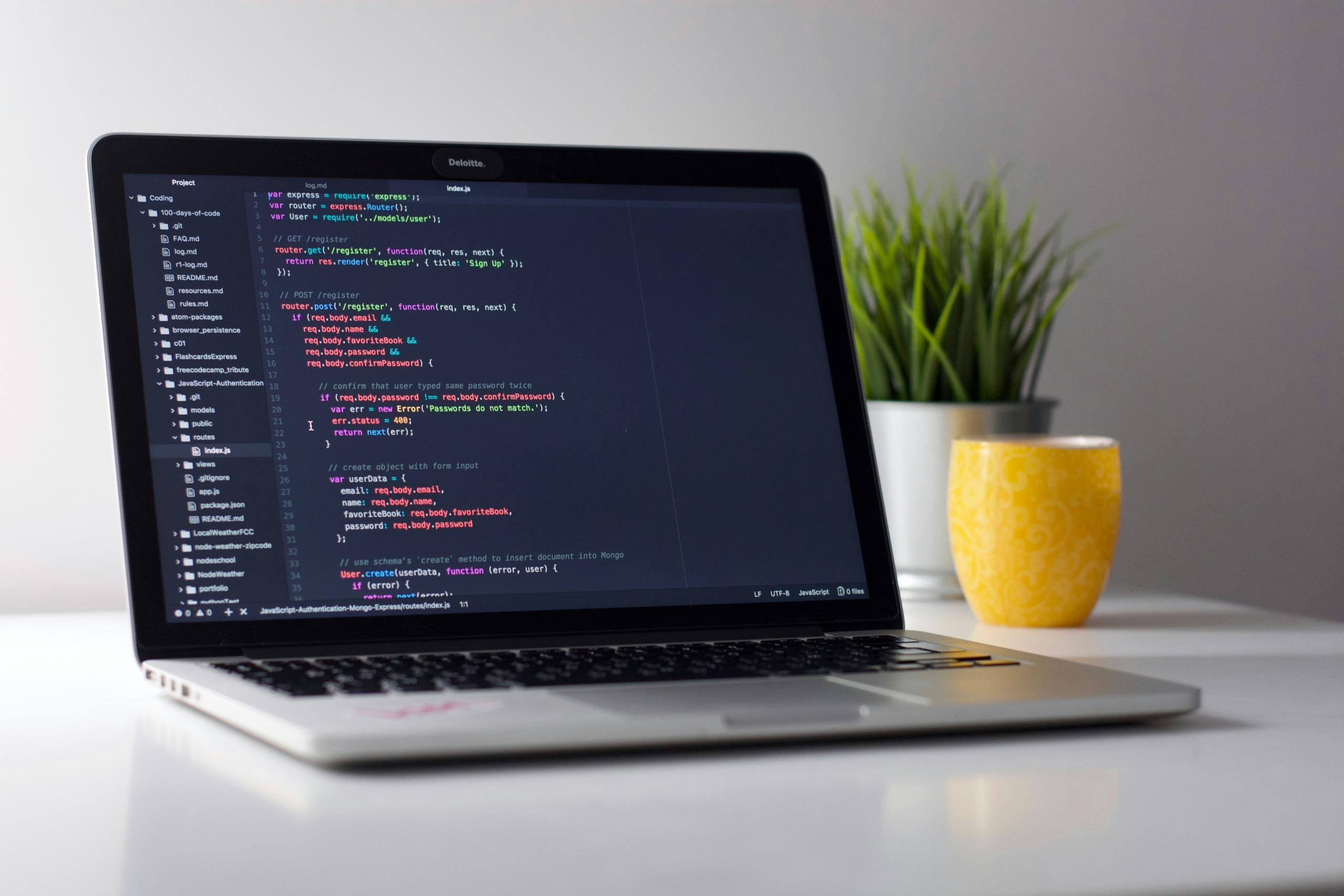 A laptop showing coding on the screen