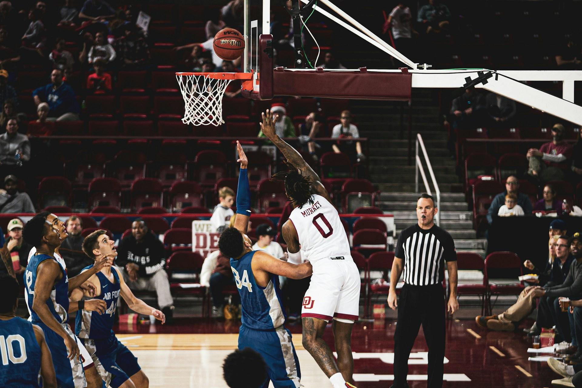 Basketball player throwing to score.