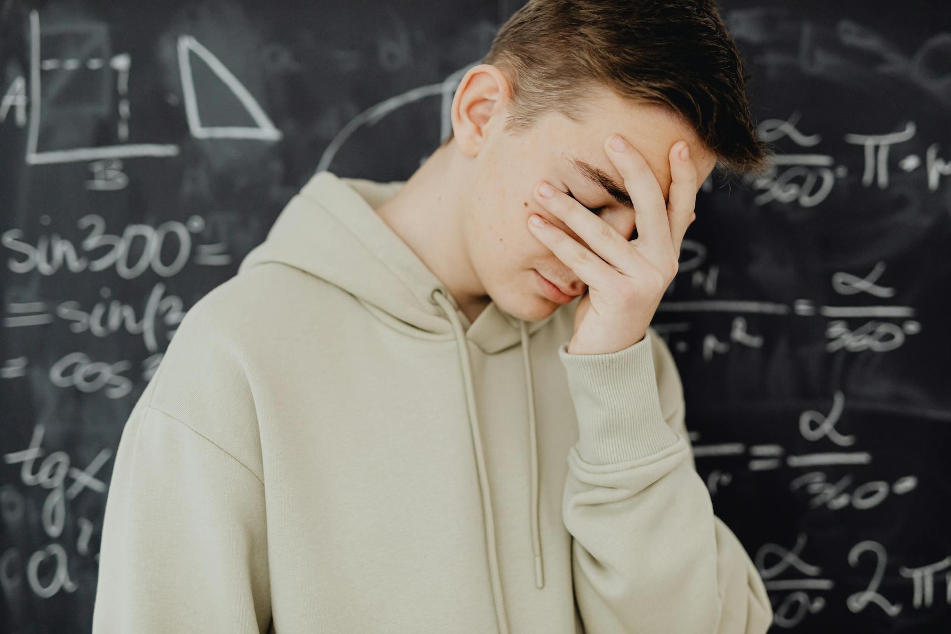 A student with his head in his hand.