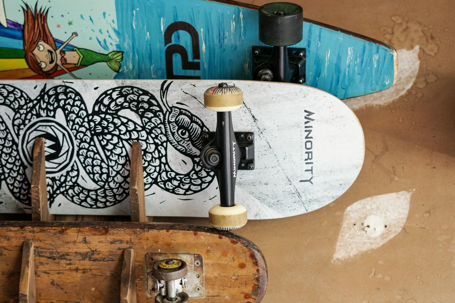 Three skateboards showing the art on the bottom of their decks