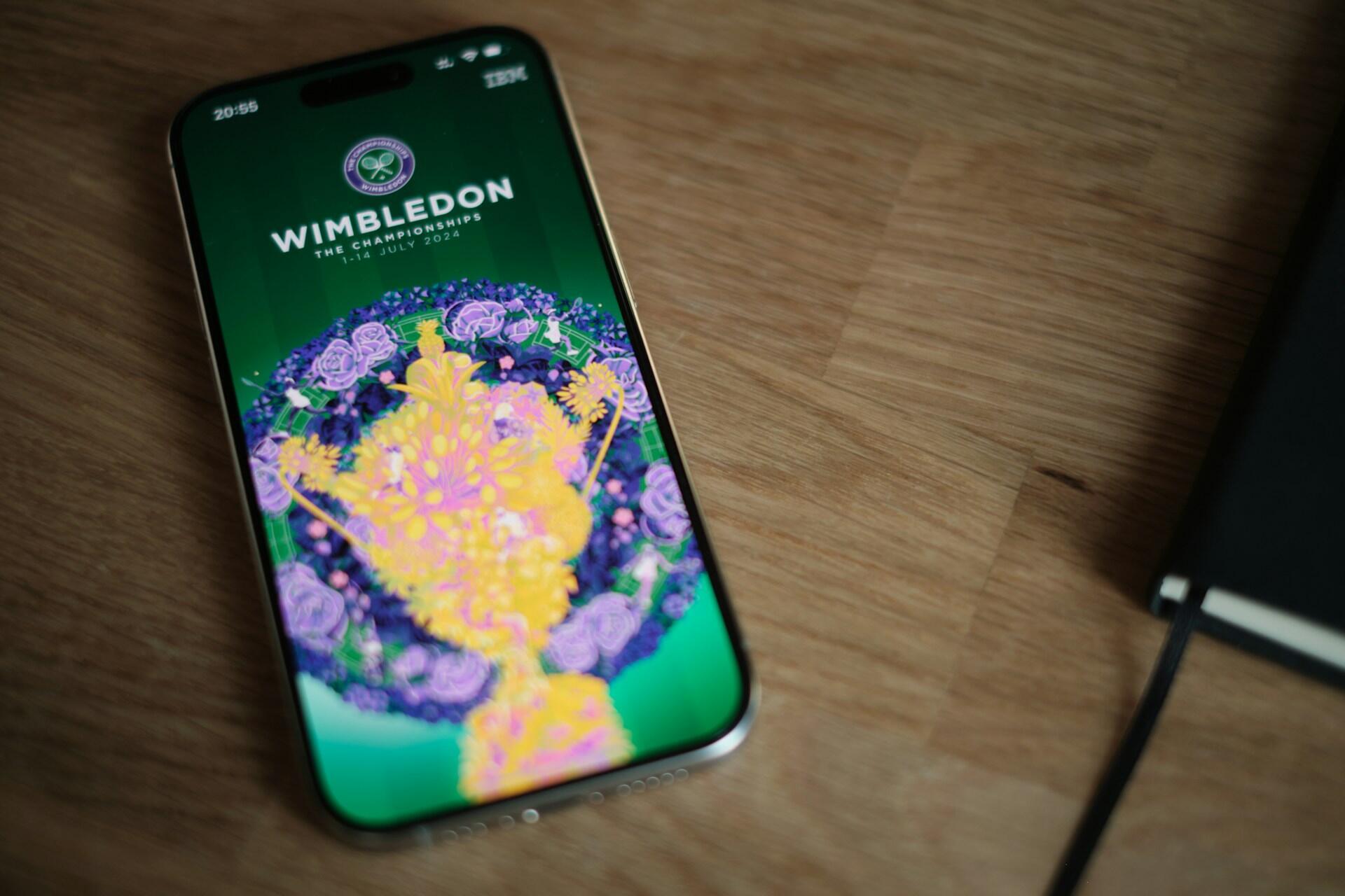Smartphone showing the Wimbledon Championships app on a wooden surface.