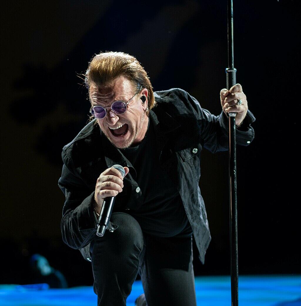 Bono performing on stage in Tokyo.