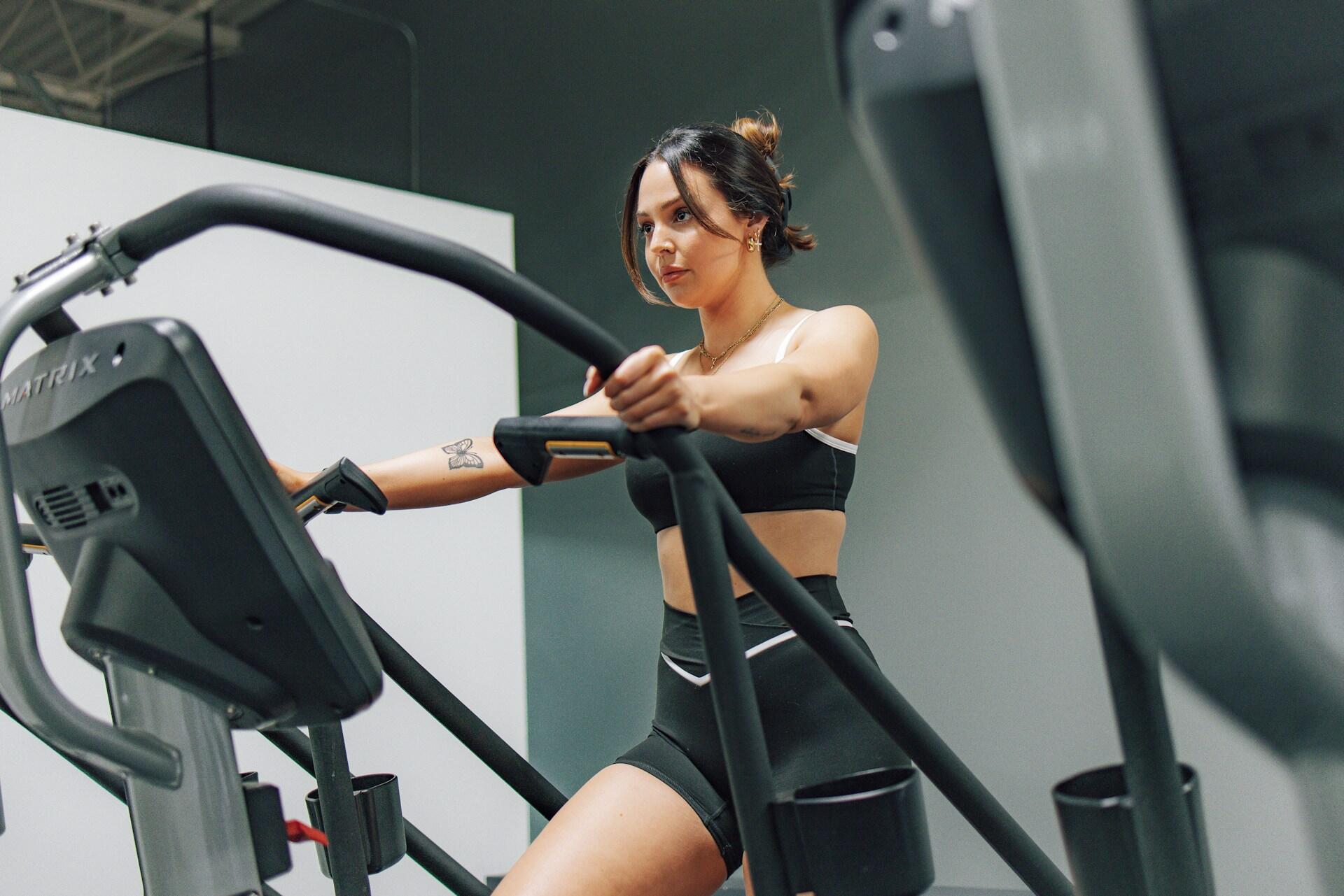 Woman exercising on a cardio machine in a gym