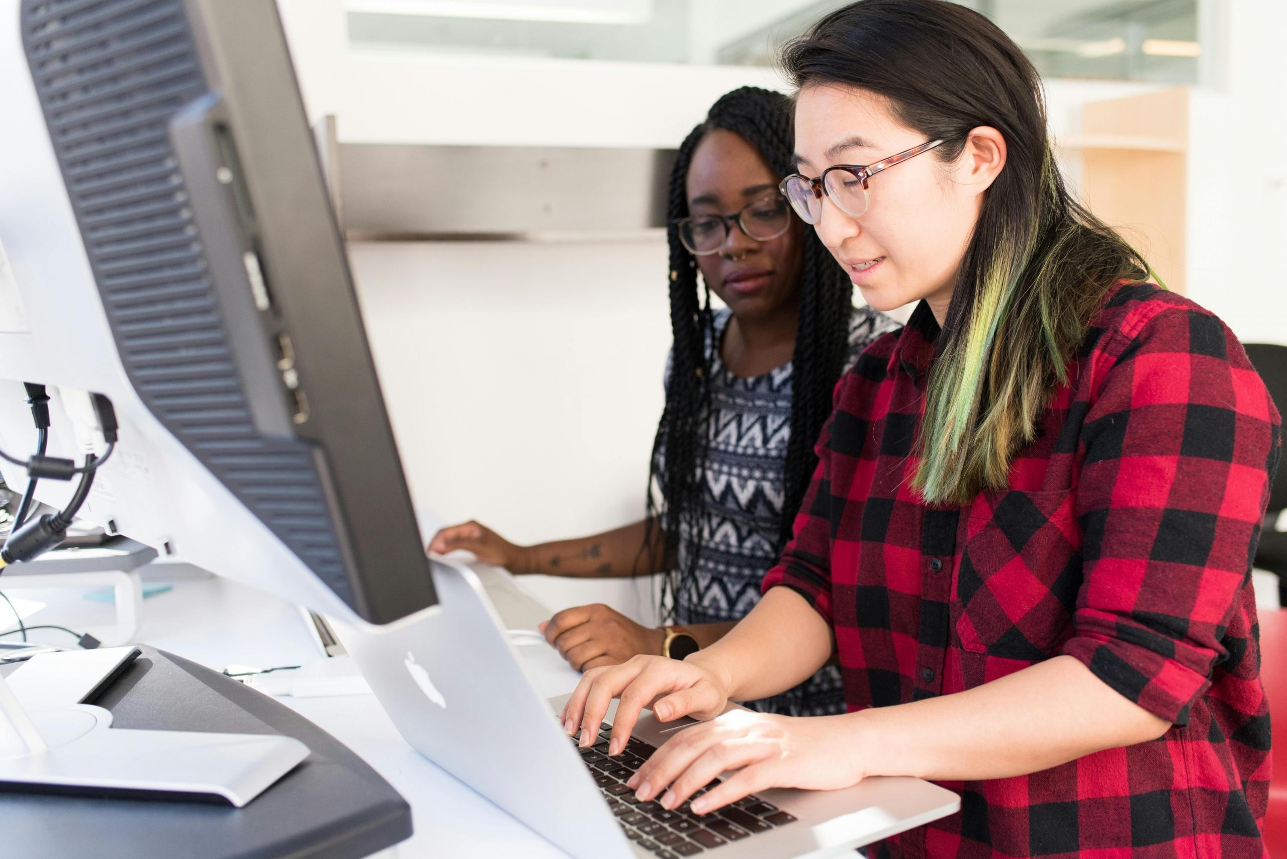 a tutor and her student looking on a screen