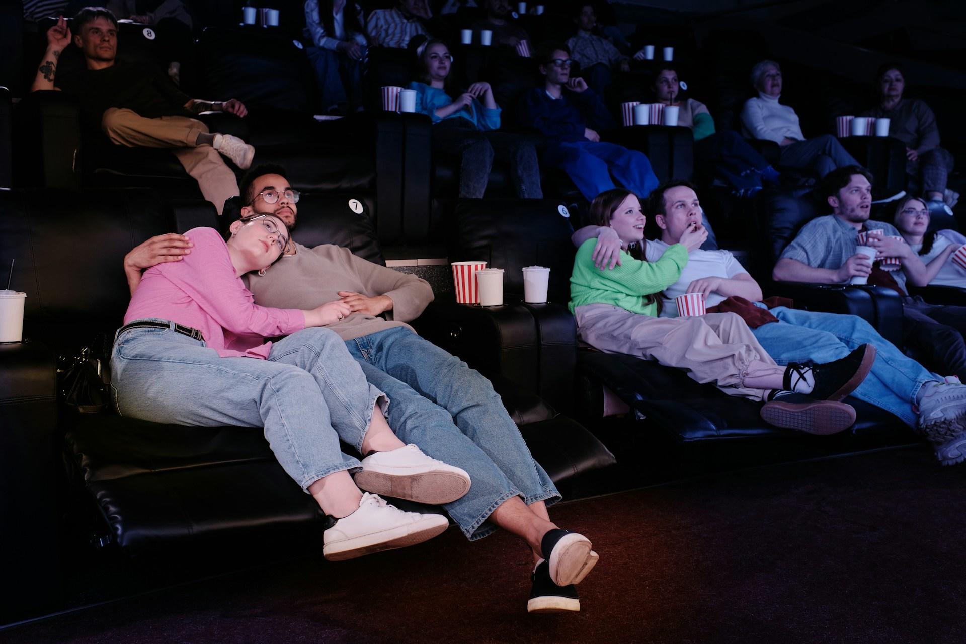 Couples cuddling in a cinema. 