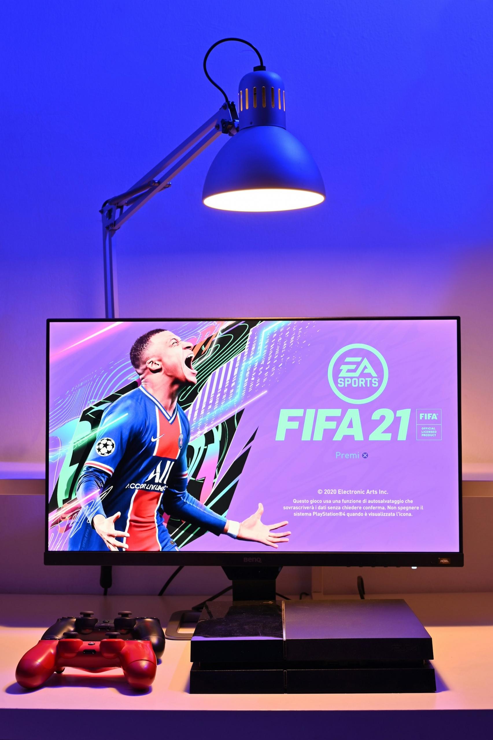 A monitor displaying a the opening screen for a fifa video game. 