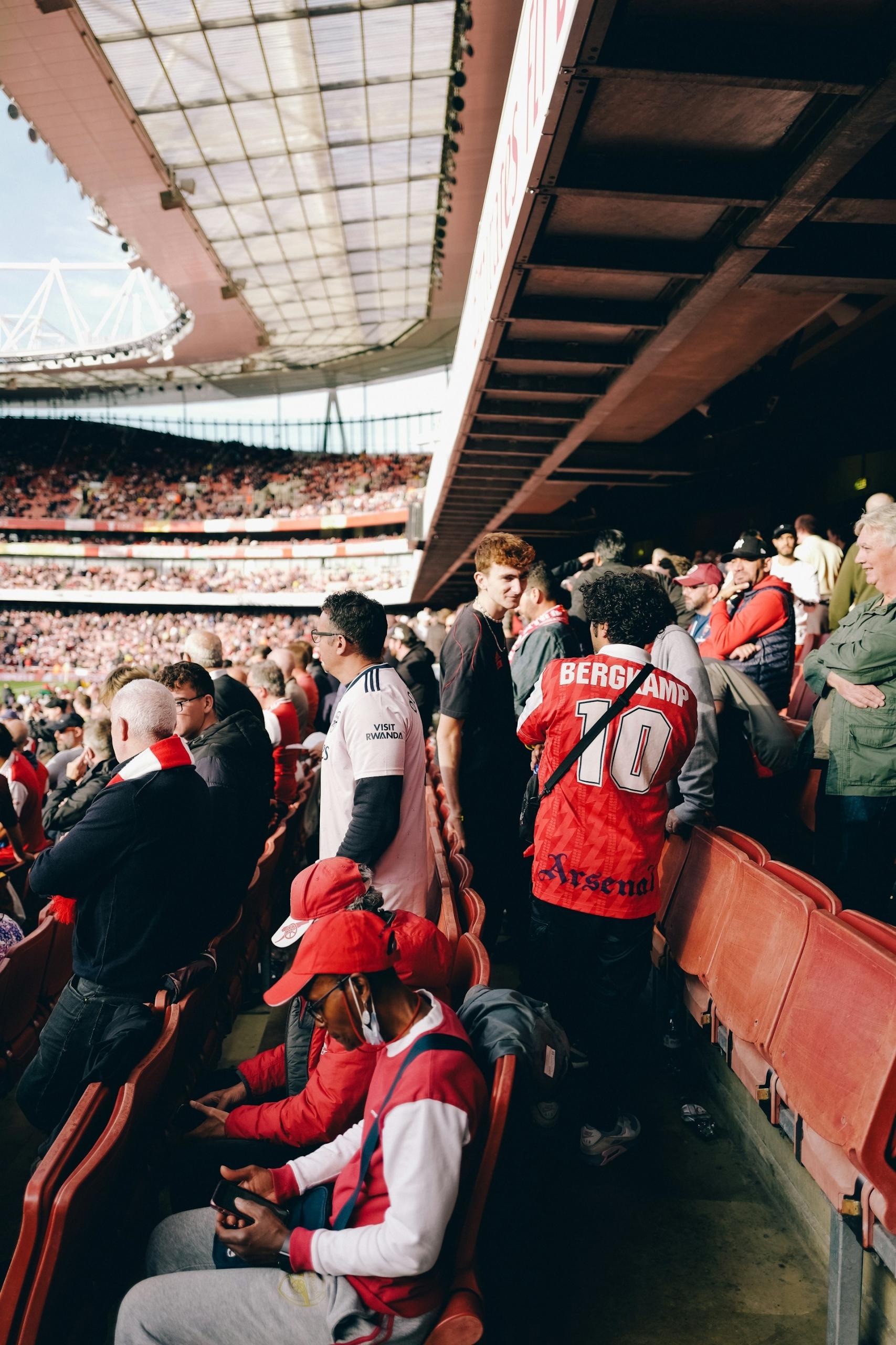 Football fans minging in the stadium stands.