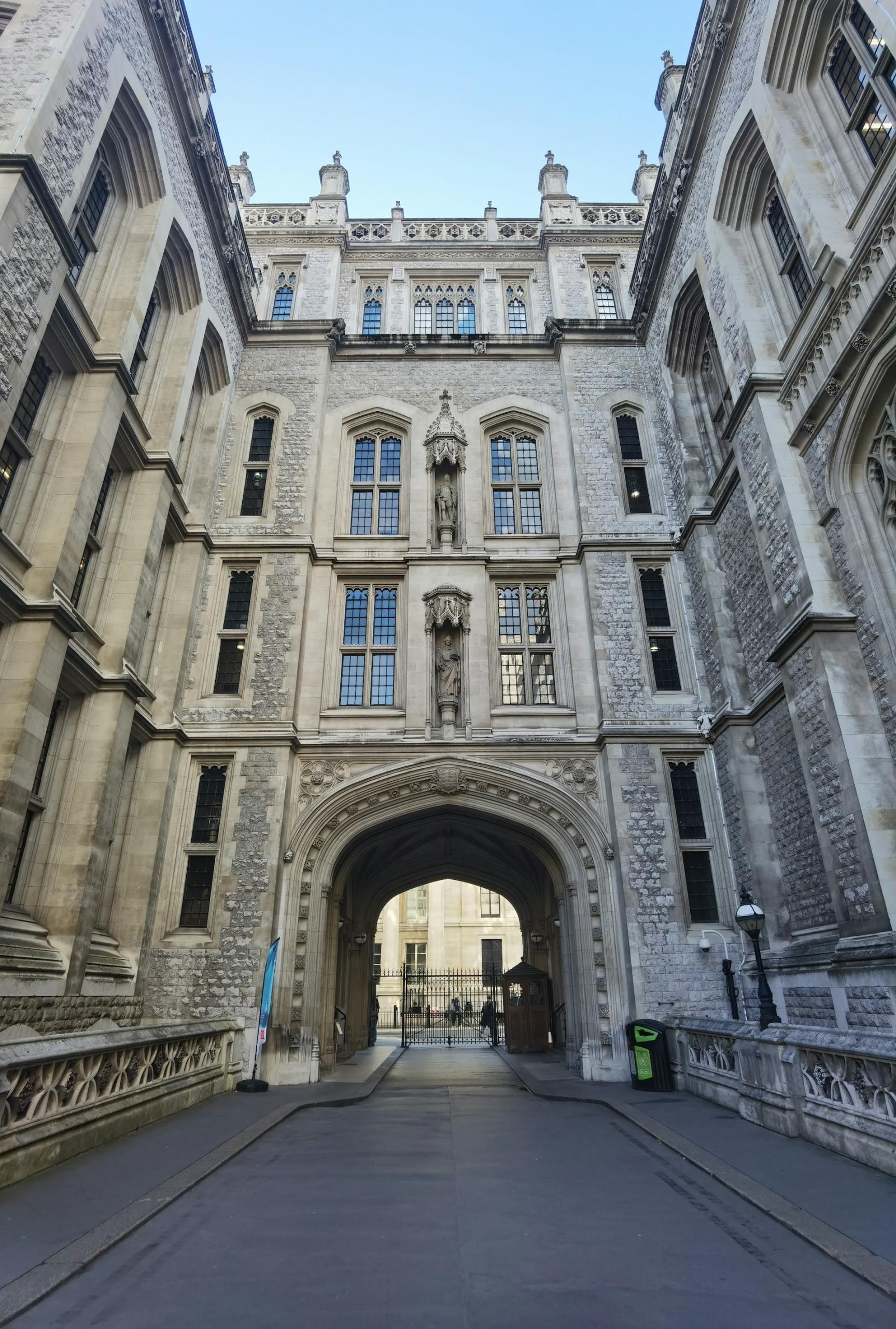A tall stone building looms over an empty street