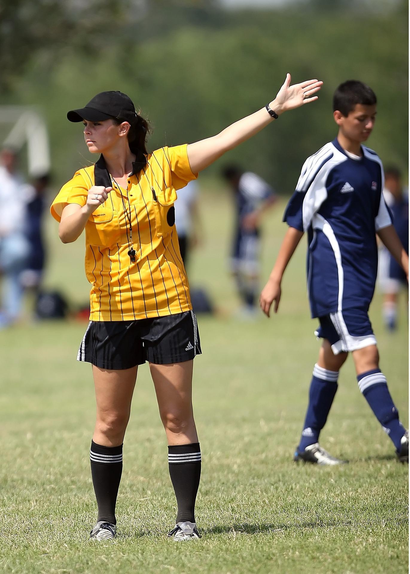 A woman wearing yellow and black sports attire on a sunny day.