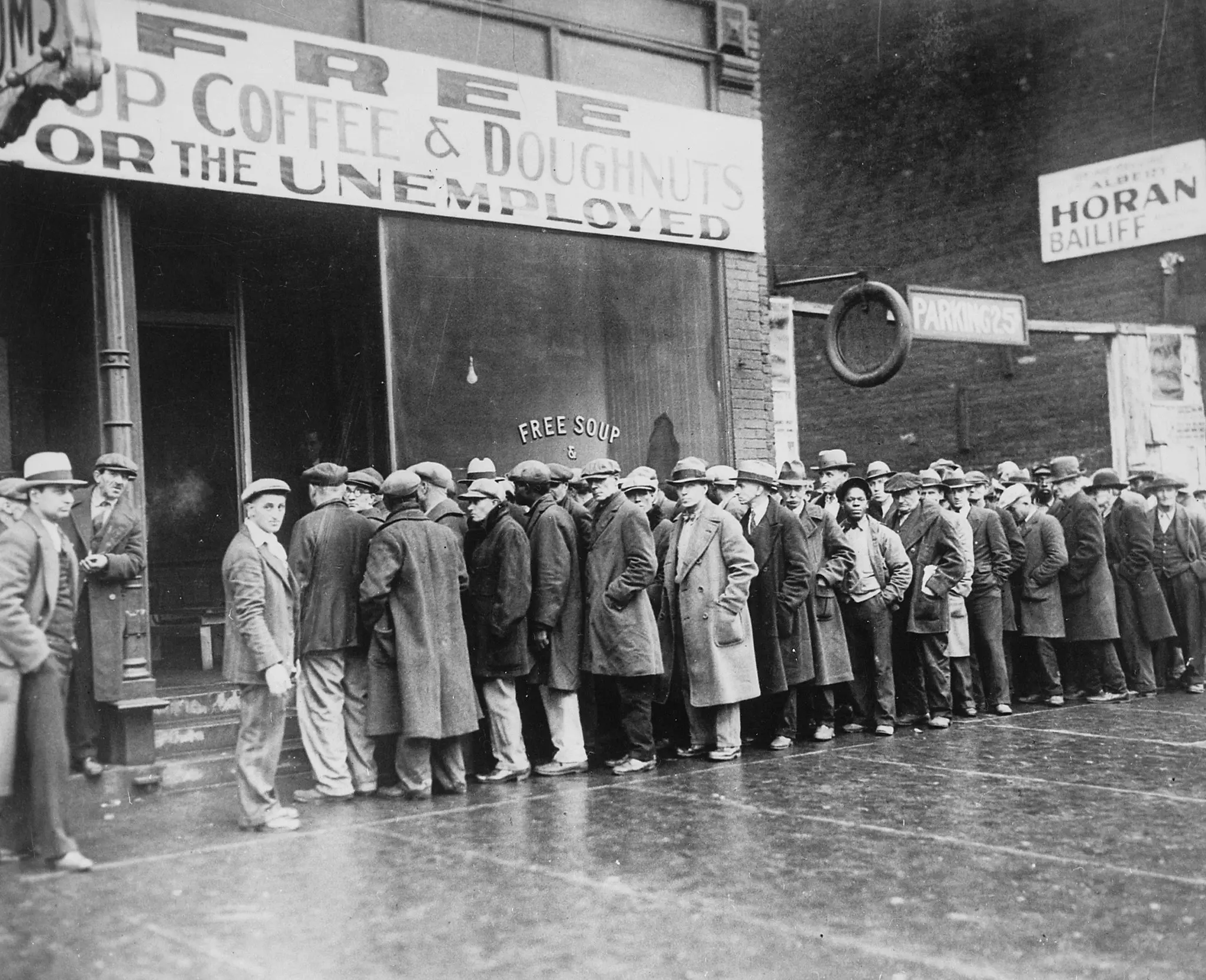 unemployed people standing outside of a soup kitchen