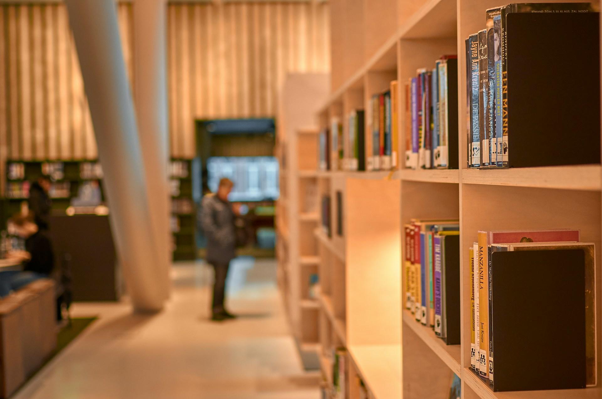 A library with a man standing down the hallway.