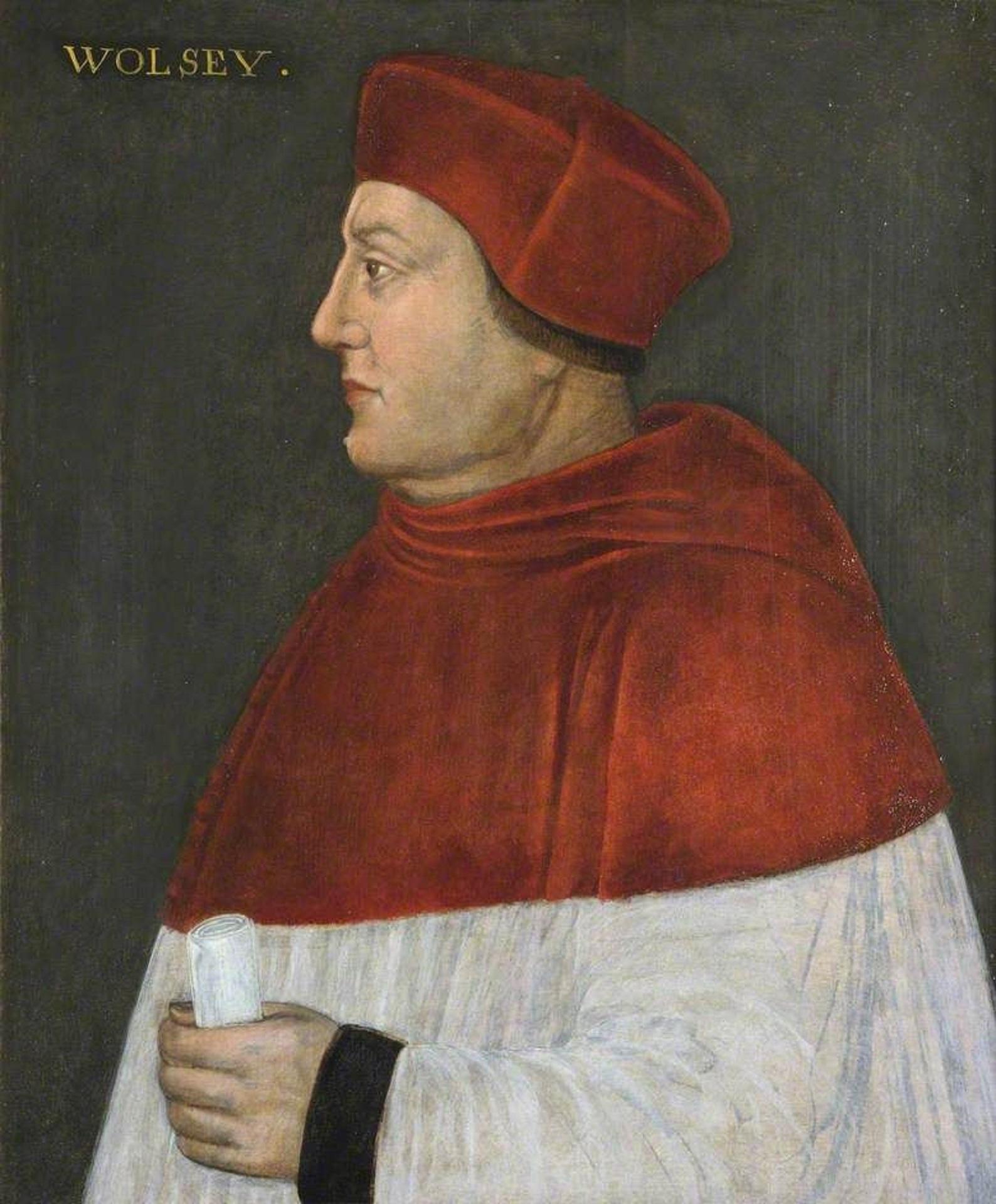 A man wearing a red and white robe, with a red hat. 
