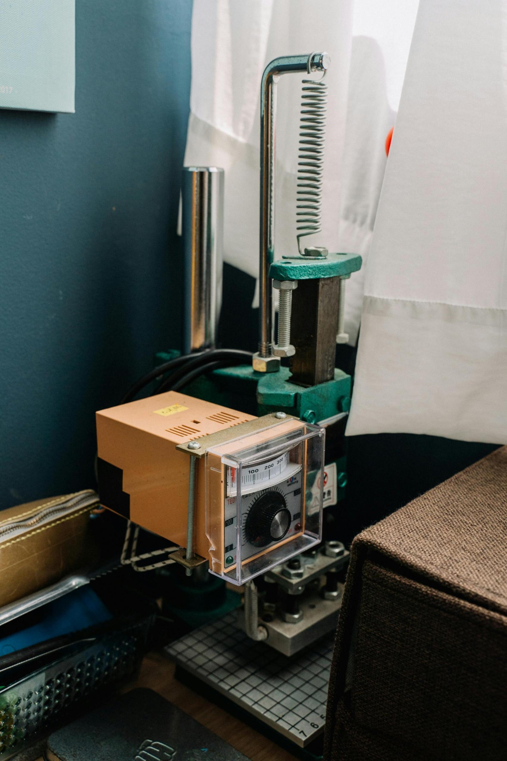 The inside of a lab that is using a hydraulic presser to flatten objects