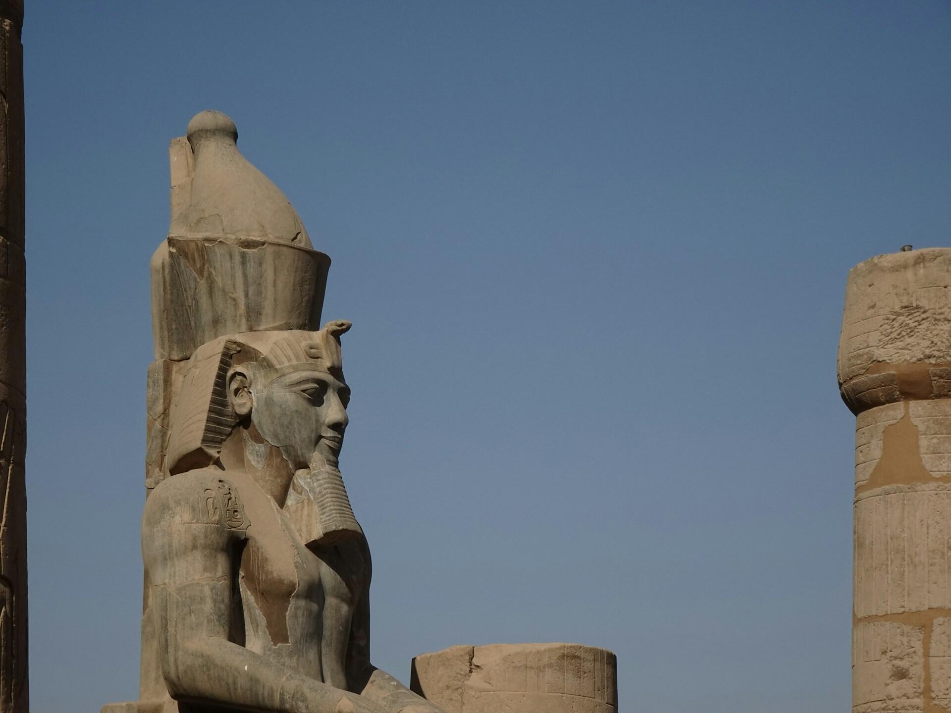 A statue of Ramses II at dusk.